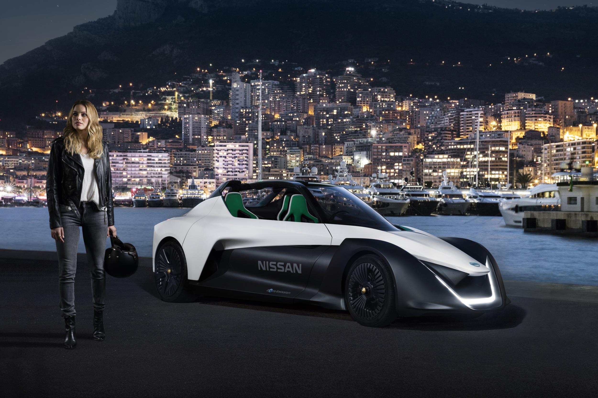 Margot Robbie posing with Nissan Electric Vehicle BladeGlider sports car